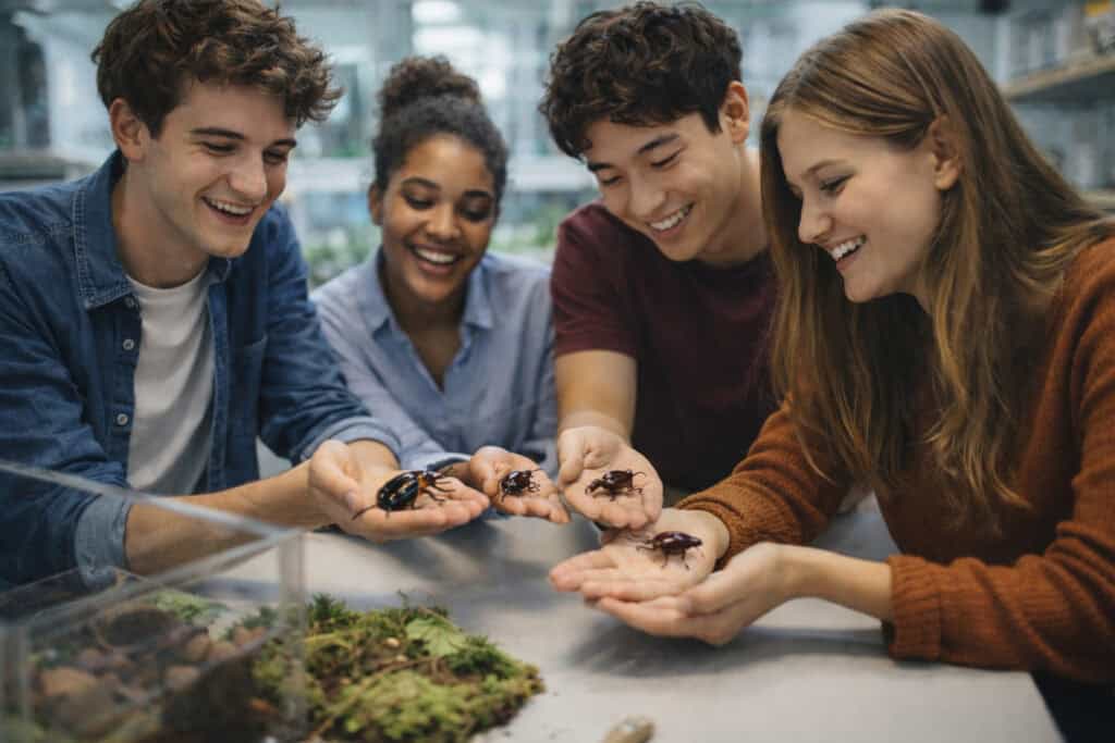Students building confidence during a resilience workshop handling insects in a UK classroom Creature Courage